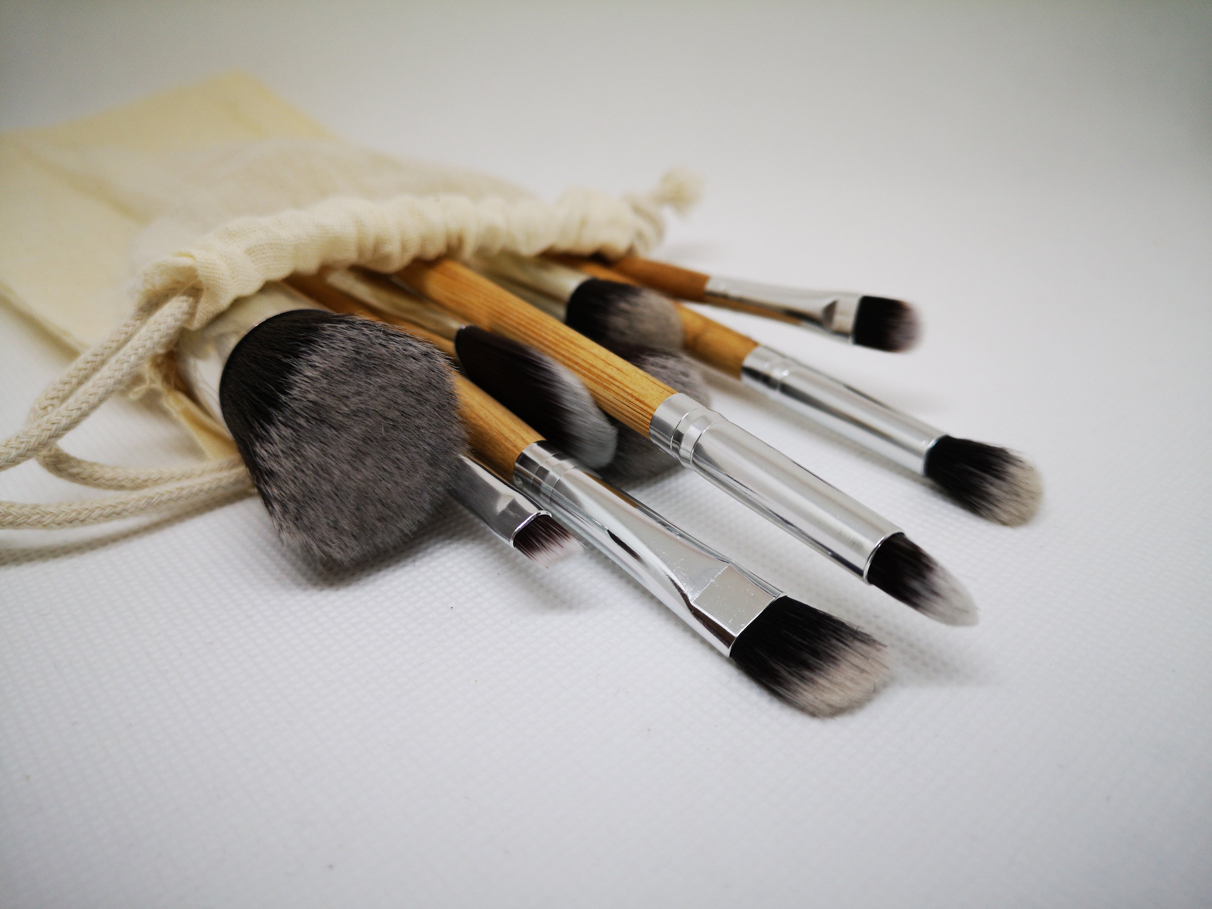 files/a-group-of-paint-brushes-spill-out-of-a-cream-linen-bag.jpg